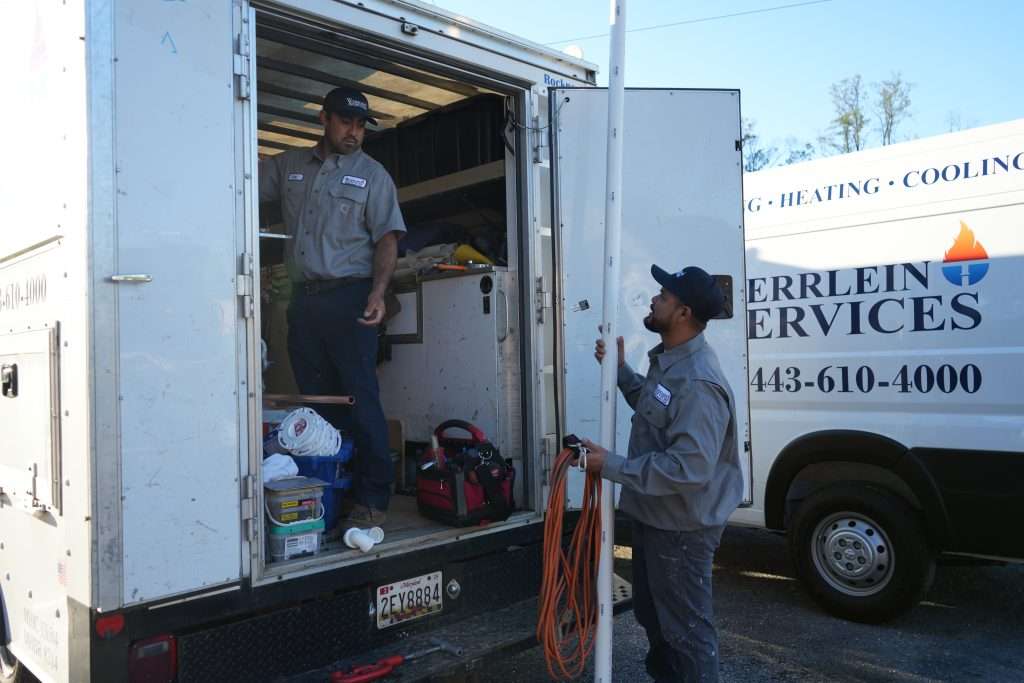 The Werrlein Companies employees grabbing gear out of the back of the company truck