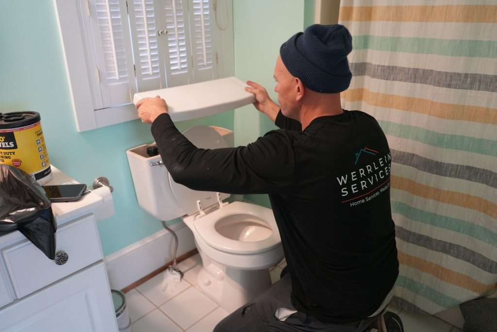 Plumber fixing a broken toilet