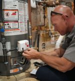 The Werrlein Companies employee services a water heater