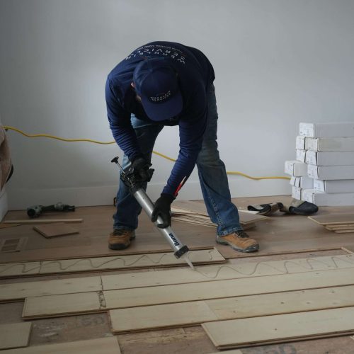 Wood flooring installation with a glue gun